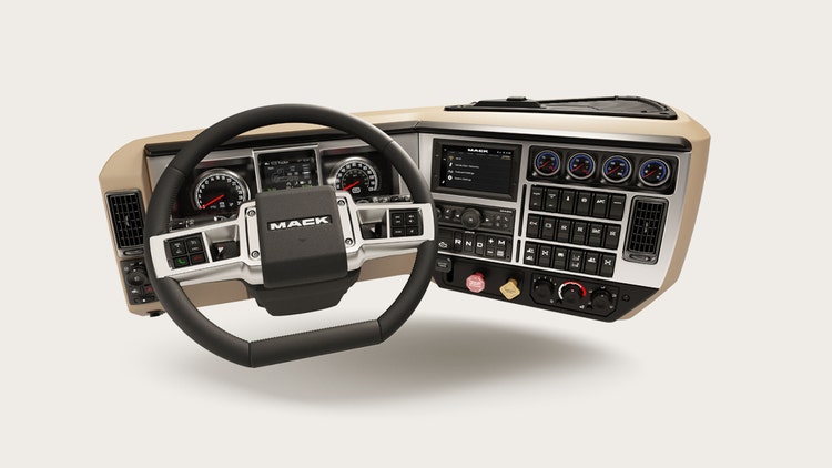 Mack truck wraparound dash featuring a D-shaped steering wheel, easy-to-reach controls, and a modern instrument cluster