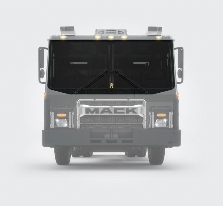 Front view of a Mack LR Series truck cab with a large windshield and wide, dual-pane wipers, designed for superior visibility