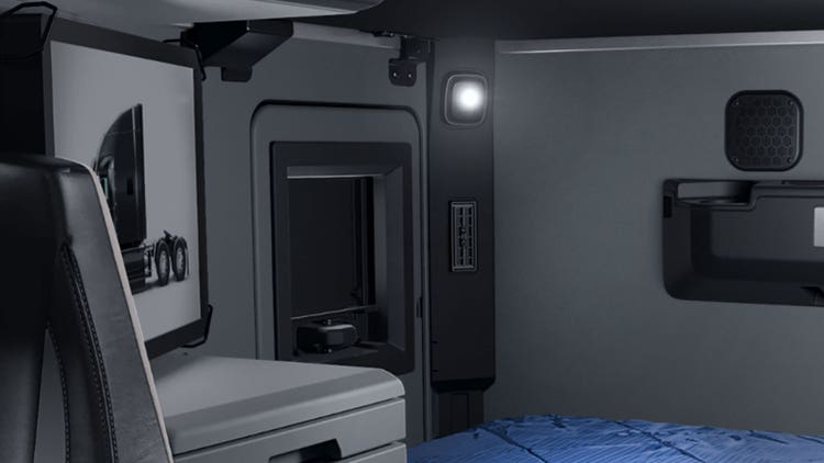 A room with a blue bed and a light