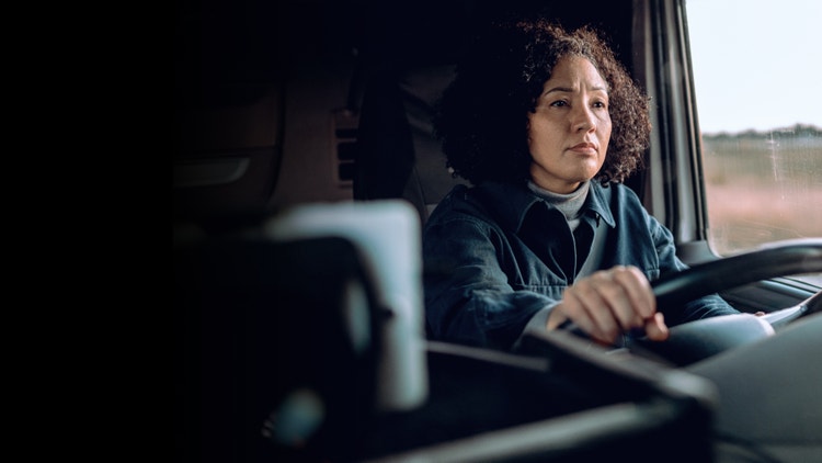 Closeup of a lady driving the truck.